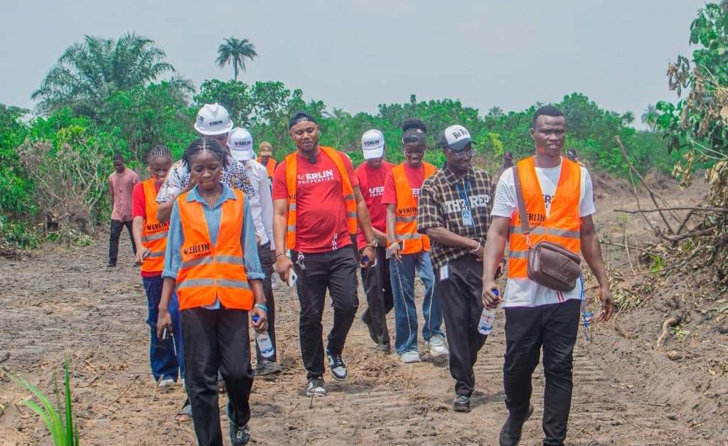 Realtors in Verlin safety vests walking a graded access road
