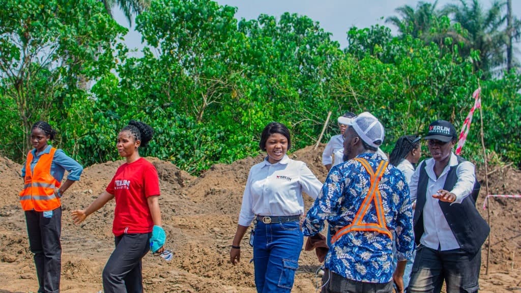 Verlin staff in branded kit walking a cleared estate plot